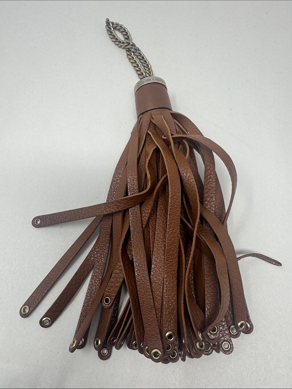 MICHAEL KORS FROM A PURSE CHARM TASSEL